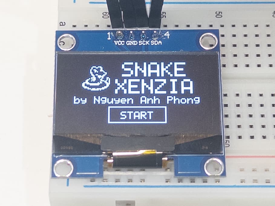 Snake Xenzia running on an STM32F411 breadboard prototype with an OLED display and buttons